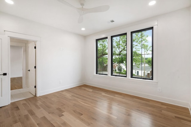 empty room with recessed lighting, light wood-style floors, baseboards, and ceiling fan