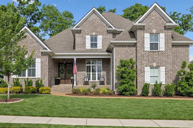 1567 Bunbury Dr, Thompsons Station, TN 37179 - view of front of property with french doors, a shingled roof, a front lawn, and brick siding