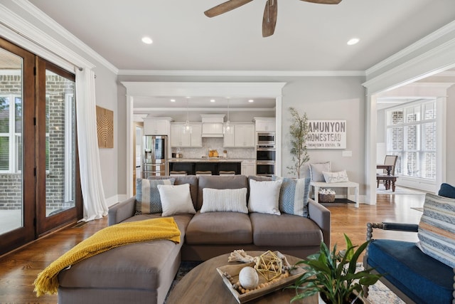 1567 Bunbury Dr, Thompsons Station, TN 37179 - living area featuring plenty of natural light, ceiling fan, wood finished floors, crown molding, and baseboards
