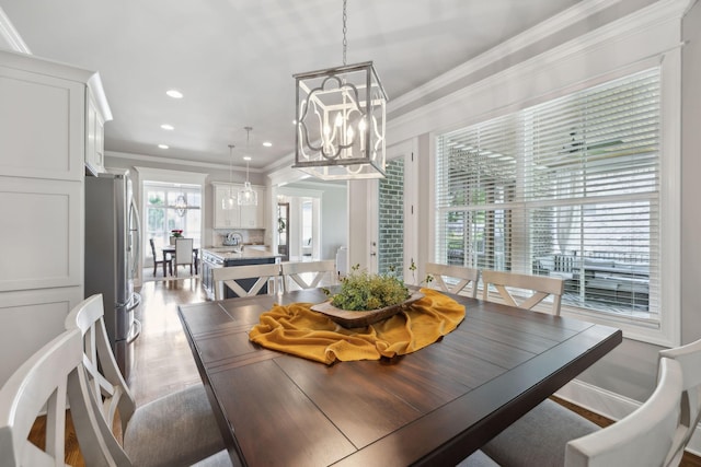 1567 Bunbury Dr, Thompsons Station, TN 37179 - dining room featuring a chandelier, wood finished floors, recessed lighting, crown molding, and baseboards