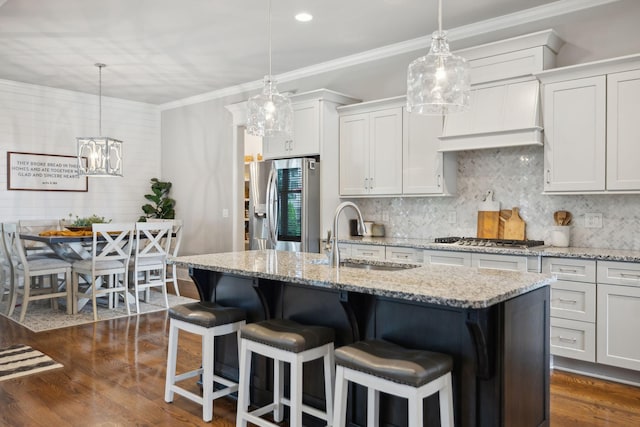 1567 Bunbury Dr, Thompsons Station, TN 37179 - kitchen with stainless steel appliances, a sink, backsplash, a kitchen island with sink, and dark wood-style floors