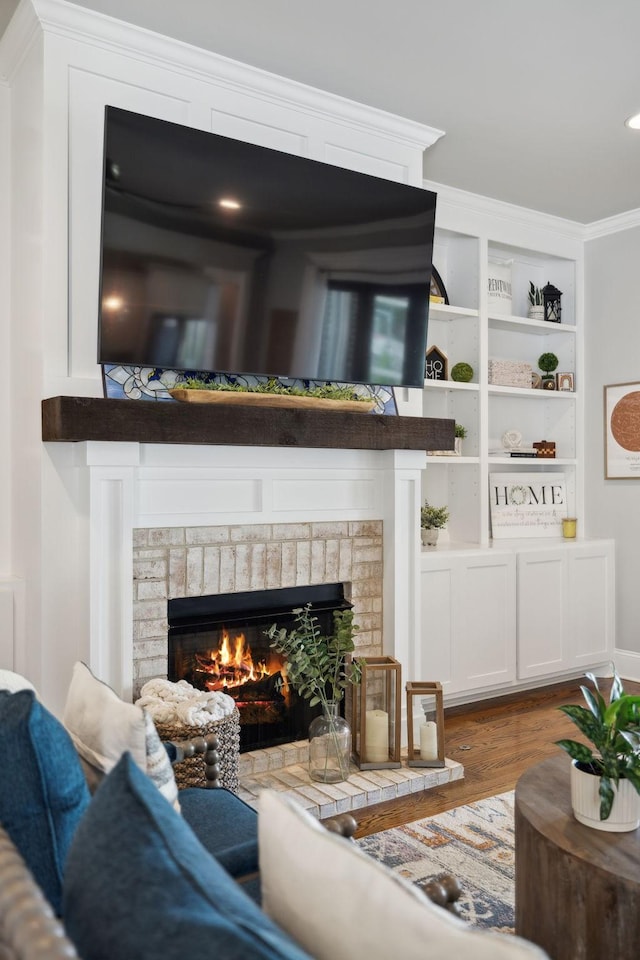 1567 Bunbury Dr, Thompsons Station, TN 37179 - living area featuring a brick fireplace, wood finished floors, ornamental molding, and built in features