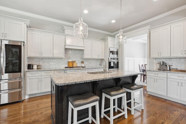 1567 Bunbury Dr, Thompsons Station, TN 37179 - kitchen with stainless steel appliances, a sink, a breakfast bar area, white cabinets, and recessed lighting