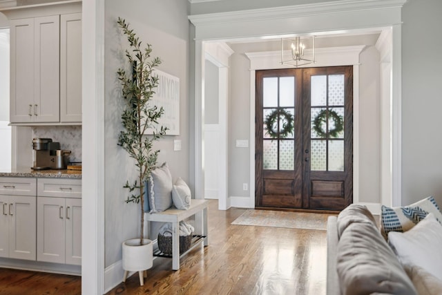 1567 Bunbury Dr, Thompsons Station, TN 37179 - entrance foyer with crown molding, wood finished floors, baseboards, french doors, and a chandelier