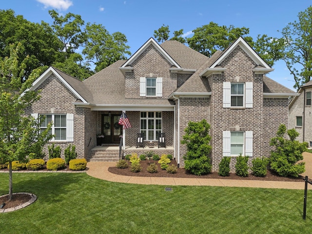 1567 Bunbury Dr, Thompsons Station, TN 37179 - view of front of property with a shingled roof, brick siding, and a front lawn