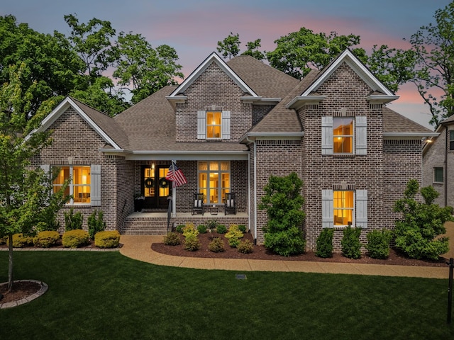 1567 Bunbury Dr, Thompsons Station, TN 37179 - view of front facade with a shingled roof, a front lawn, and brick siding