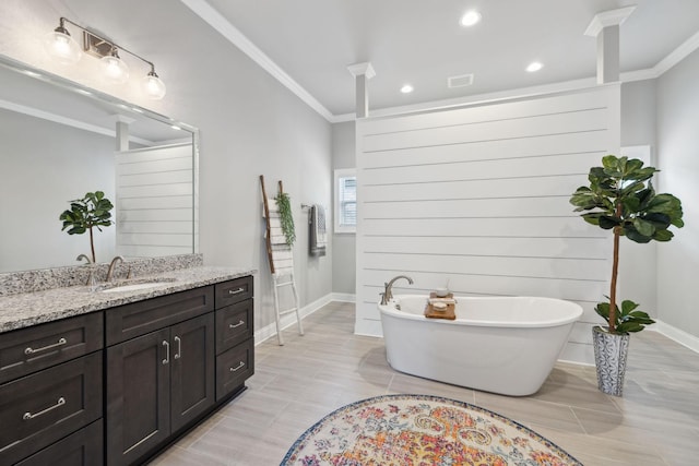 1567 Bunbury Dr, Thompsons Station, TN 37179 - full bathroom with ornamental molding, vanity, a soaking tub, baseboards, and recessed lighting