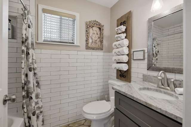 bathroom with toilet, tile walls, vanity, shower / bathtub combination with curtain, and wainscoting