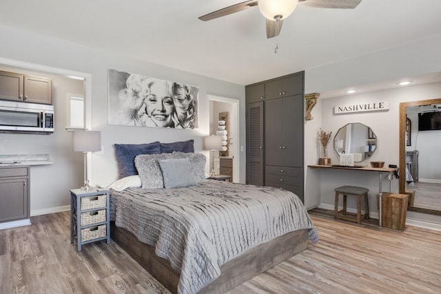 bedroom with light wood finished floors, baseboards, a closet, and ceiling fan