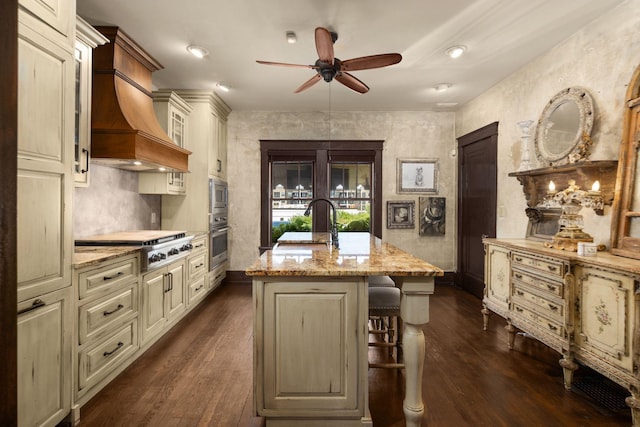 kitchen with appliances with stainless steel finishes, ceiling fan, light stone counters, dark wood-style floors, and recessed lighting