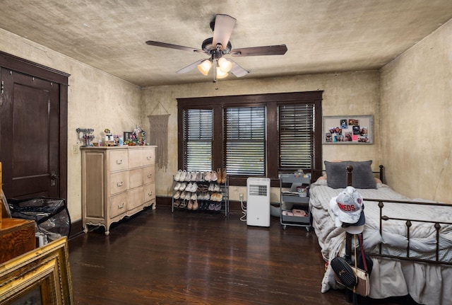 bedroom featuring wood-type flooring and a ceiling fan