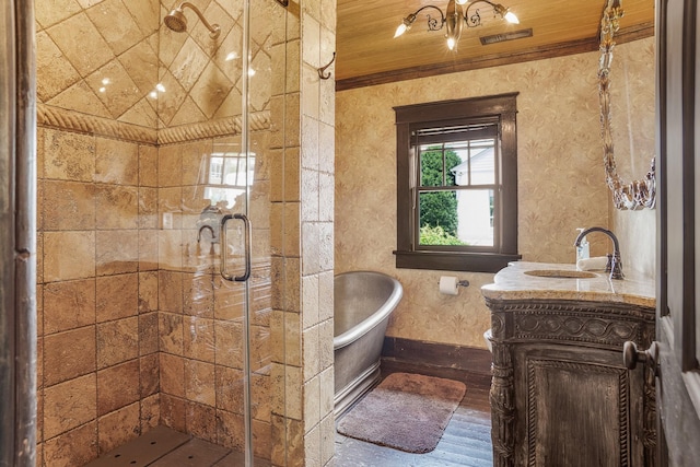 bathroom with a stall shower, a freestanding bath, vanity, crown molding, and wood finished floors