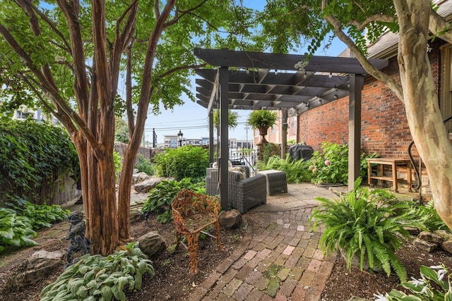 view of patio / terrace featuring a pergola and fence