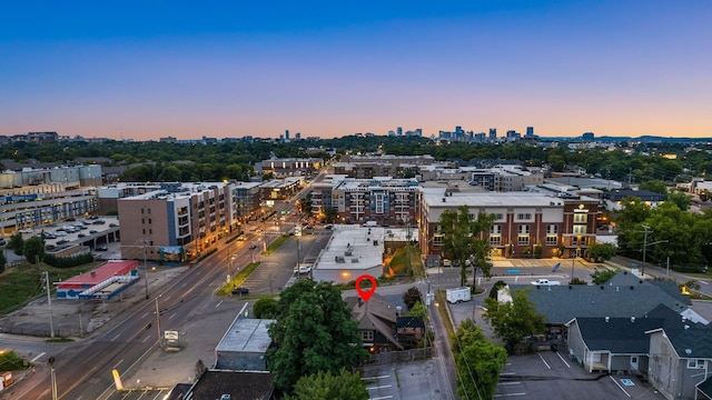 aerial view of property and surrounding area with nearby urban area