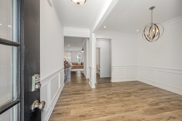 3628 Pelham Wood Dr, Murfreesboro, TN 37128 - foyer entrance with ornamental molding, a decorative wall, light wood-style flooring, a chandelier, and a wainscoted wall