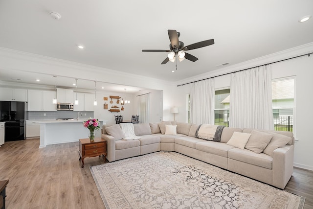 3628 Pelham Wood Dr, Murfreesboro, TN 37128 - living room featuring crown molding, ceiling fan, light wood-type flooring, a chandelier, and recessed lighting