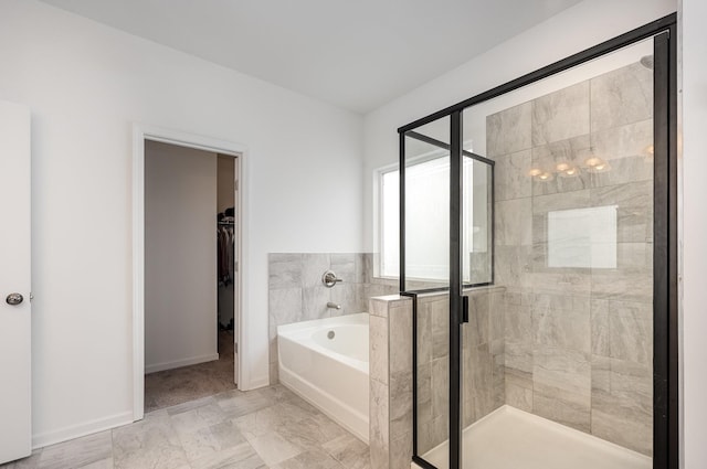 3628 Pelham Wood Dr, Murfreesboro, TN 37128 - bathroom with a bath, a walk in closet, a shower stall, and baseboards