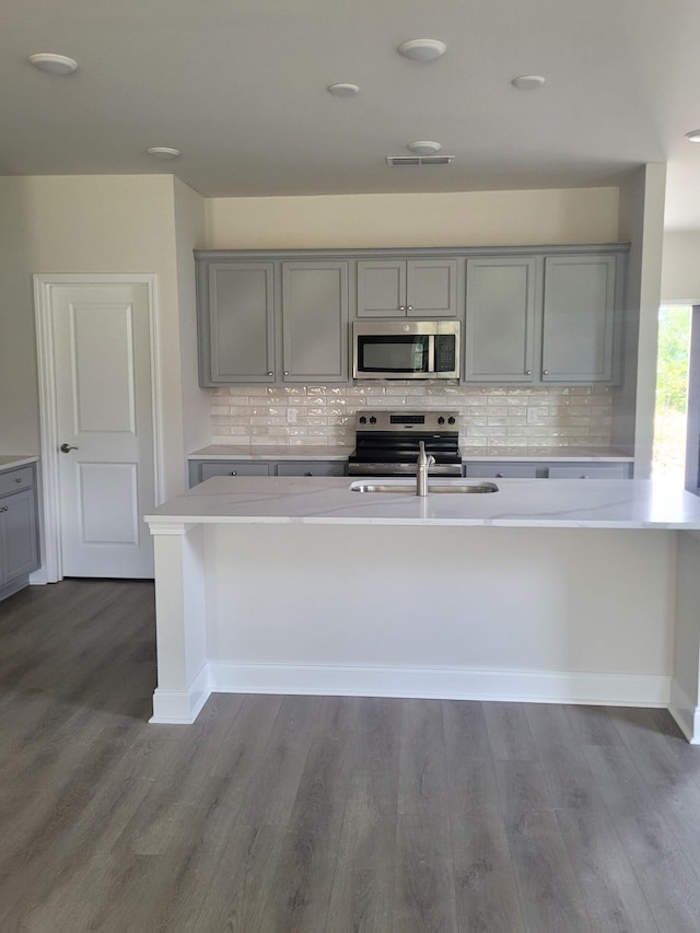 116 Holly Rdg, Antioch, TN 37013 - kitchen with gray cabinetry, stainless steel appliances, light countertops, and tasteful backsplash