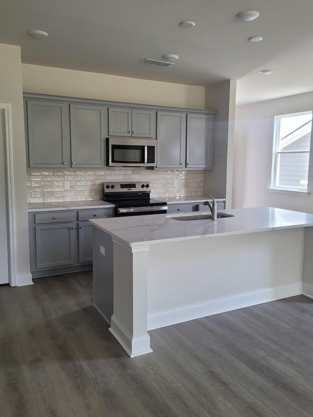 116 Holly Rdg, Antioch, TN 37013 - kitchen featuring gray cabinets, appliances with stainless steel finishes, dark wood-style floors, and tasteful backsplash