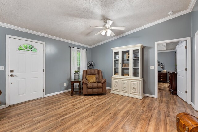 1056 Simms Heights Rd, Kingston Springs, TN 37082 - sitting room featuring light wood-type flooring, a textured ceiling, ceiling fan, crown molding, and baseboards