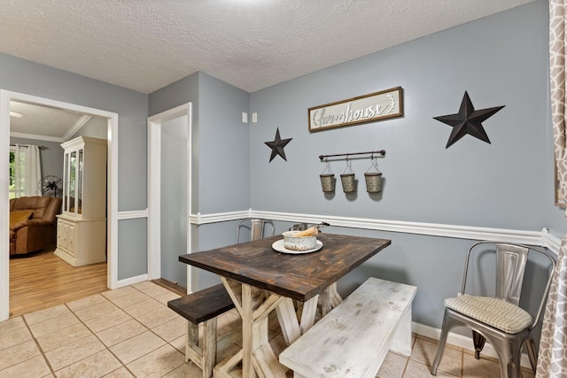 1056 Simms Heights Rd, Kingston Springs, TN 37082 - dining room featuring light tile patterned floors, ornamental molding, and a textured ceiling
