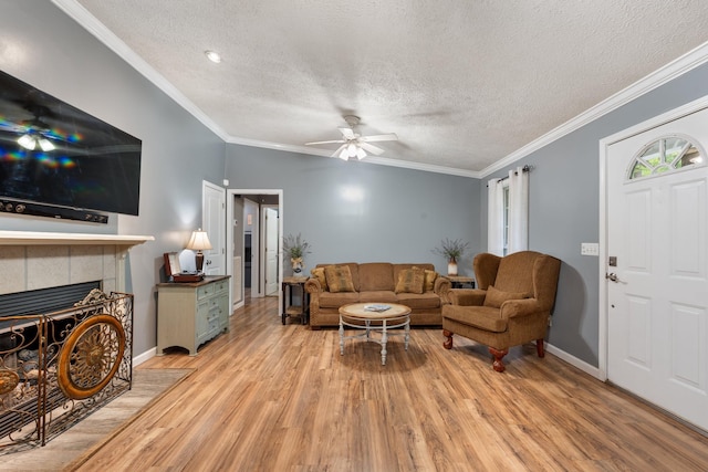 1056 Simms Heights Rd, Kingston Springs, TN 37082 - living room with ceiling fan, light wood finished floors, a textured ceiling, a fireplace, and baseboards