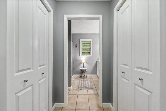 1056 Simms Heights Rd, Kingston Springs, TN 37082 - corridor featuring a textured ceiling, light tile patterned flooring, and baseboards