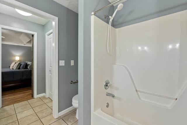 1056 Simms Heights Rd, Kingston Springs, TN 37082 - bathroom featuring tile patterned floors, toilet, shower / washtub combination, baseboards, and ensuite bathroom