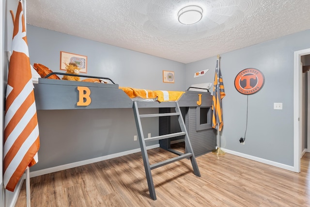 1056 Simms Heights Rd, Kingston Springs, TN 37082 - bedroom with wood finished floors, baseboards, and a textured ceiling