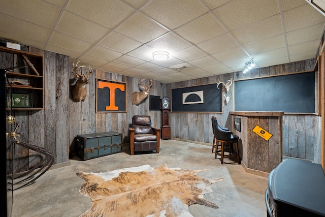 1056 Simms Heights Rd, Kingston Springs, TN 37082 - living room with a drop ceiling, concrete flooring, wooden walls, and baseboards