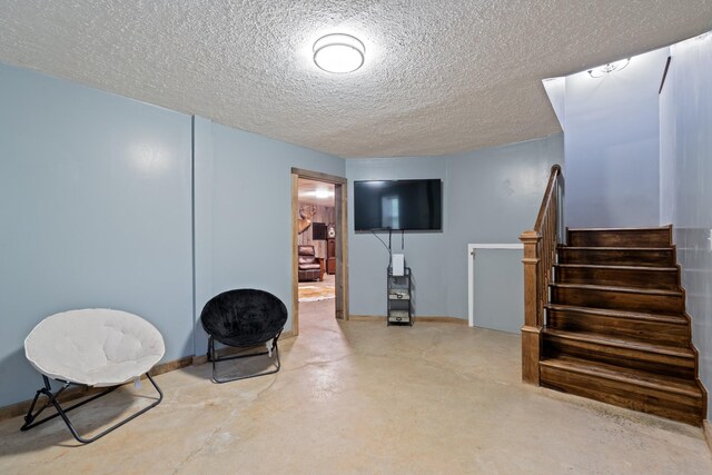 1056 Simms Heights Rd, Kingston Springs, TN 37082 - living area featuring concrete floors, stairs, a textured ceiling, and baseboards