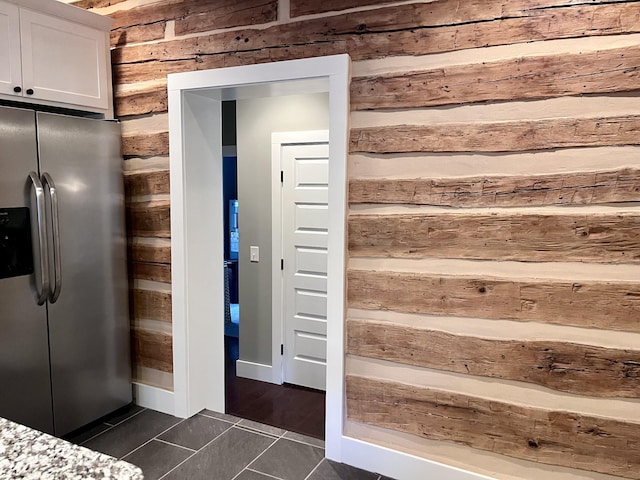 219 Garner St, Springfield, TN 37172 - kitchen view of stainless steel refrigerator with ice dispenser, wood walls, and white cabinetry