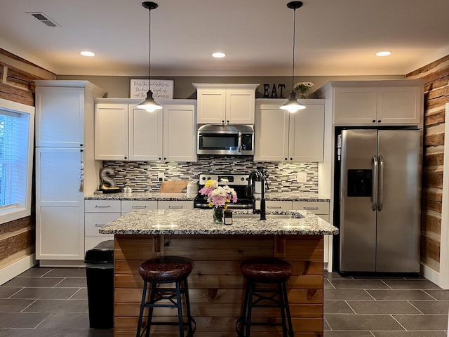 219 Garner St, Springfield, TN 37172 - kitchen featuring appliances with stainless steel finishes, dark tile patterned flooring, backsplash, and recessed lighting
