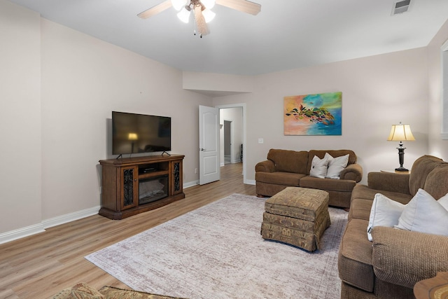 313 Red Feather Ln, Brentwood, TN 37027 - living area with ceiling fan, wood finished floors, baseboards, and a glass covered fireplace