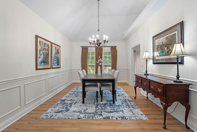 313 Red Feather Ln, Brentwood, TN 37027 - dining room with a chandelier, a decorative wall, wood finished floors, lofted ceiling, and a wainscoted wall