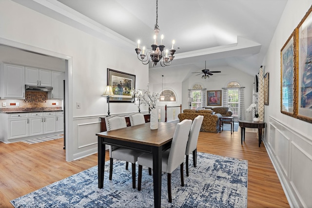 313 Red Feather Ln, Brentwood, TN 37027 - dining space with a chandelier, light wood-style flooring, ceiling fan, wainscoting, and a tray ceiling