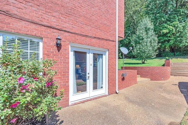 313 Red Feather Ln, Brentwood, TN 37027 - view of property exterior with french doors, a patio area, and brick siding