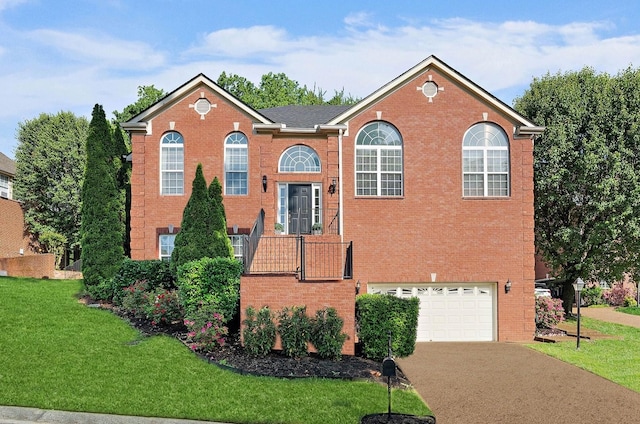 313 Red Feather Ln, Brentwood, TN 37027 - view of front of house featuring brick siding, a front yard, driveway, and a garage
