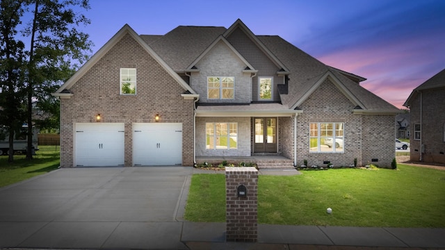 2212 Peterson Dr, Chattanooga, TN 37421 - view of front of home with concrete driveway, a yard, a garage, covered porch, and a shingled roof