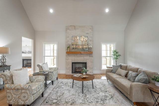 2212 Peterson Dr, Chattanooga, TN 37421 - living area featuring a stone fireplace, high vaulted ceiling, wood finished floors, plenty of natural light, and recessed lighting