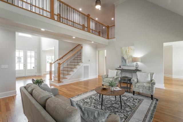 2212 Peterson Dr, Chattanooga, TN 37421 - living room featuring a high ceiling, stairs, wood finished floors, ornamental molding, and recessed lighting
