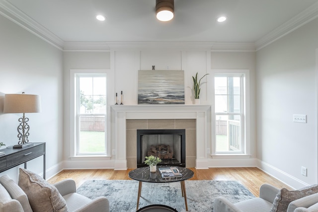 2212 Peterson Dr, Chattanooga, TN 37421 - living area with crown molding, plenty of natural light, a tile fireplace, wood finished floors, and recessed lighting