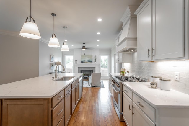 2212 Peterson Dr, Chattanooga, TN 37421 - kitchen featuring stainless steel appliances, a ceiling fan, a fireplace, backsplash, and open floor plan