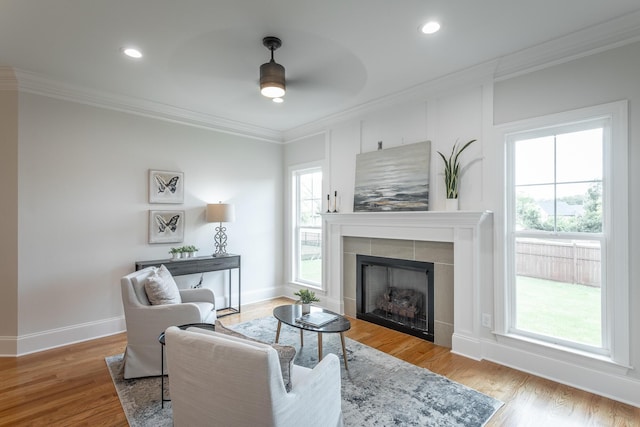 2212 Peterson Dr, Chattanooga, TN 37421 - living area featuring ornamental molding, a tiled fireplace, a ceiling fan, wood finished floors, and recessed lighting