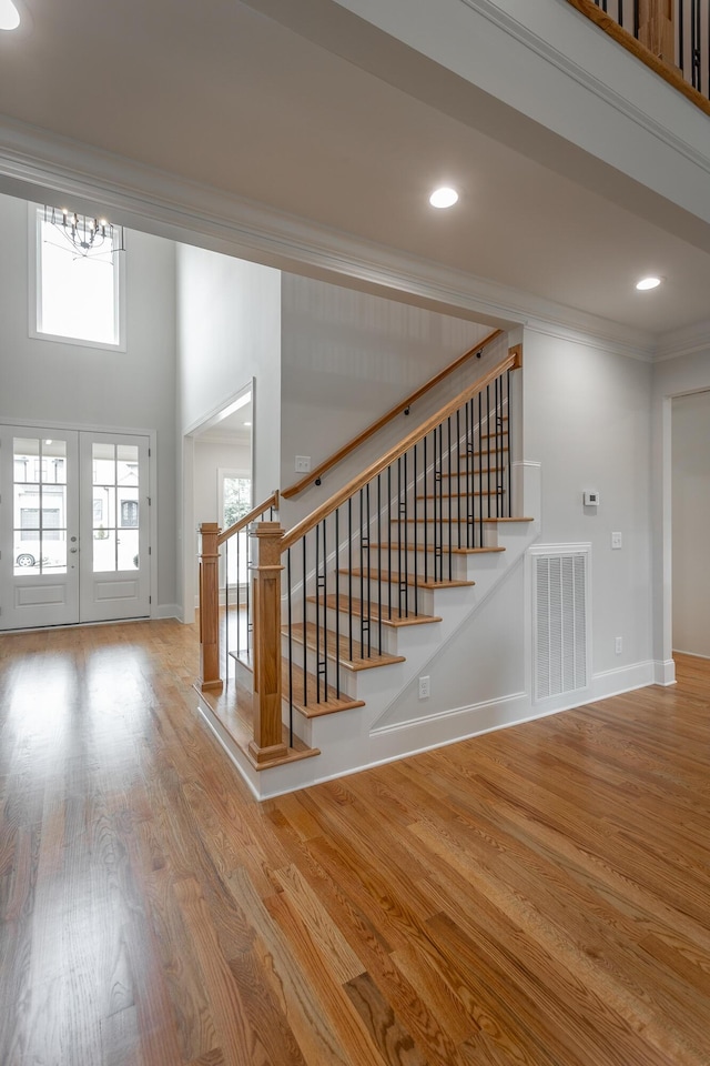 2212 Peterson Dr, Chattanooga, TN 37421 - stairs featuring crown molding, wood finished floors, a chandelier, recessed lighting, and a towering ceiling