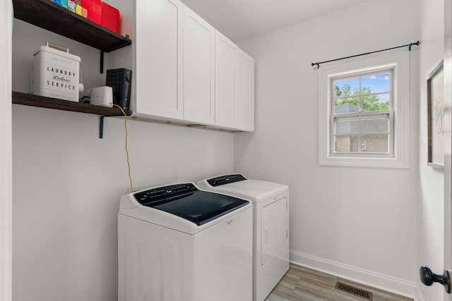 1951 Winsome Ln, Adams, TN 37010 - laundry room with washing machine and dryer, cabinet space, light wood finished floors, and baseboards