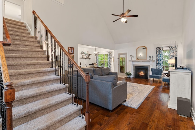 1951 Winsome Ln, Adams, TN 37010 - living room with high vaulted ceiling, plenty of natural light, stairway, dark wood-style floors, and ceiling fan
