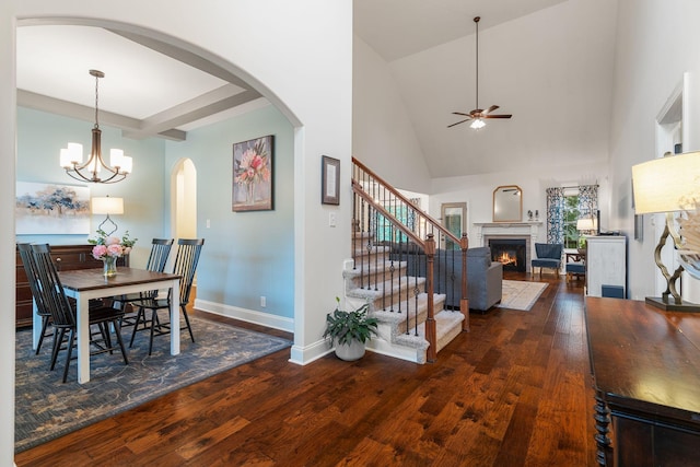 1951 Winsome Ln, Adams, TN 37010 - dining area with a ceiling fan, wood finished floors, a lit fireplace, arched walkways, and baseboards