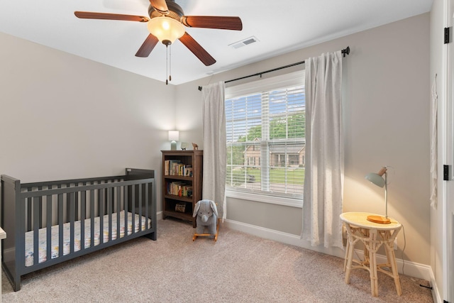 1951 Winsome Ln, Adams, TN 37010 - carpeted bedroom with baseboards, a nursery area, and a ceiling fan