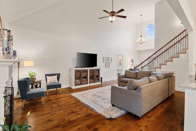 1951 Winsome Ln, Adams, TN 37010 - living room featuring high vaulted ceiling, ceiling fan, dark wood-style floors, stairs, and a chandelier